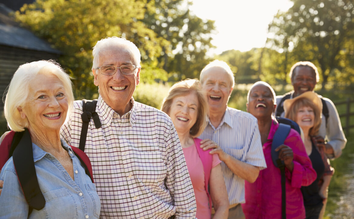 Portrait Of Senior Friends Hiking In Countryside