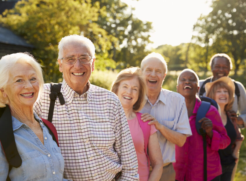 Portrait Of Senior Friends Hiking In Countryside