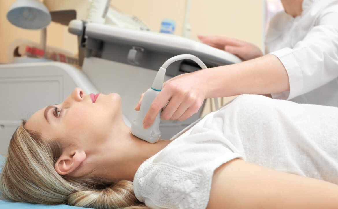 Young woman undergoing ultrasound scan in modern clinic