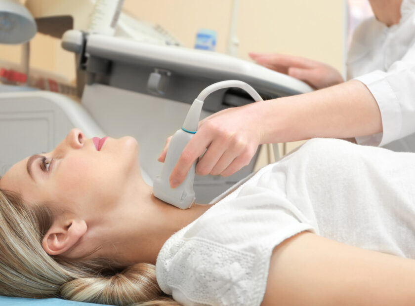 Young woman undergoing ultrasound scan in modern clinic